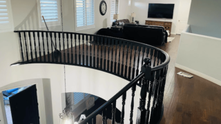 Elegant black railing with a polished wood floor in a bright living space