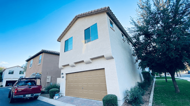 House exterior painted fresh with clean white and beige tones.