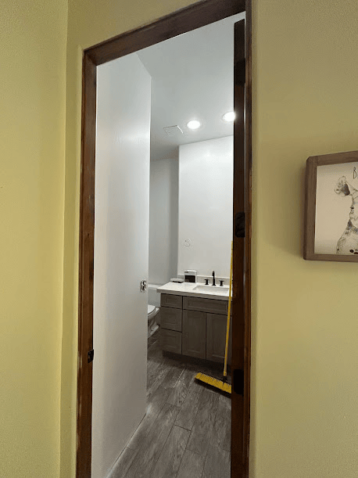 Bathroom renovation with modern vanity and fresh flooring.