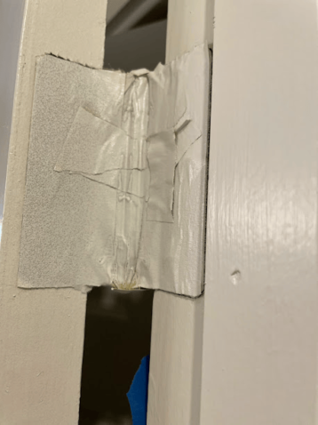 Close-up of a door with paint tape