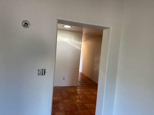 Hallway with new paint and tile flooring
