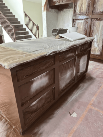 Kitchen island masked for painting.