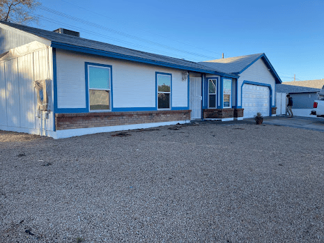 House exterior painted white with blue trim.
