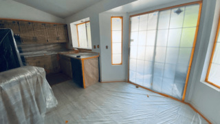 Kitchen prepared for interior painting with protective coverings