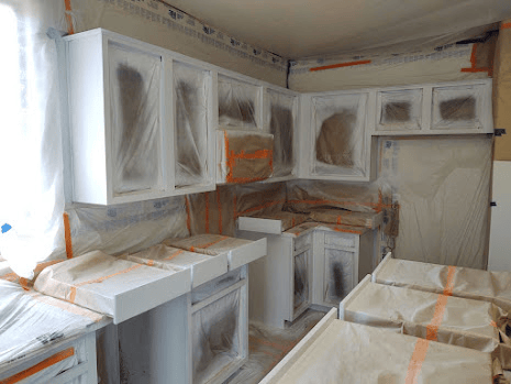 Kitchen cabinets masked for painting.