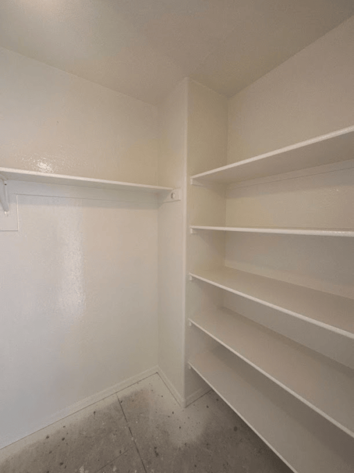 Freshly painted white closet with shelves