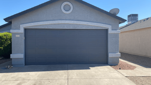 Freshly painted garage door with gray trim.