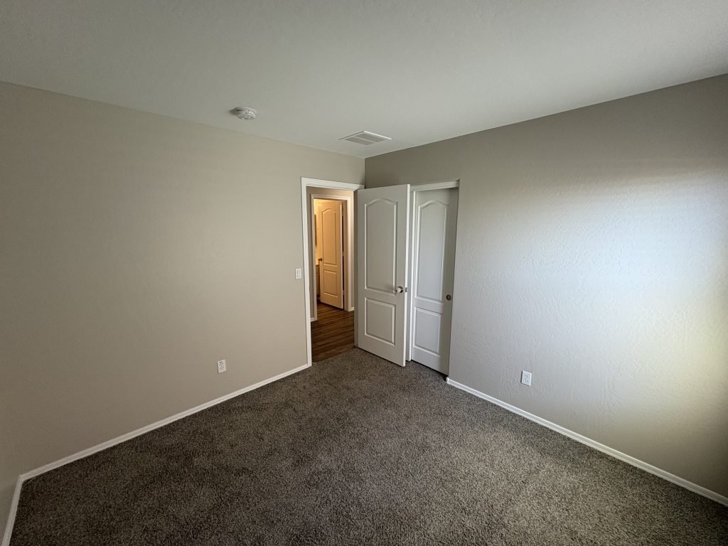 Freshly painted bedroom with grey walls and carpet