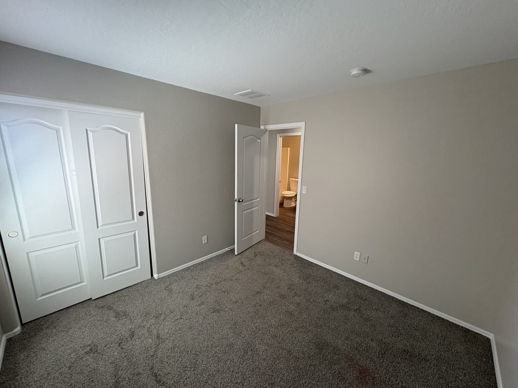 Bedroom with grey walls and carpet