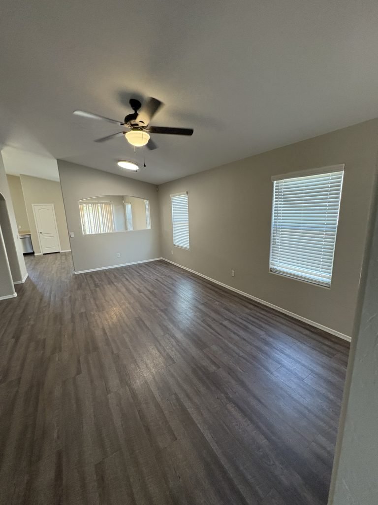 Empty room with wood flooring and a ceiling fan