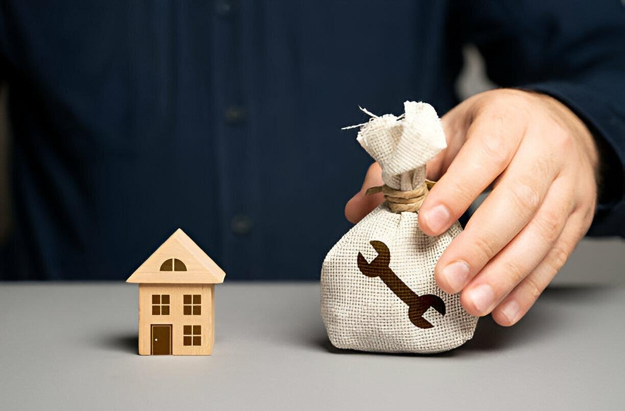 Bag of money with wrench symbol and house, representing painting service costs.