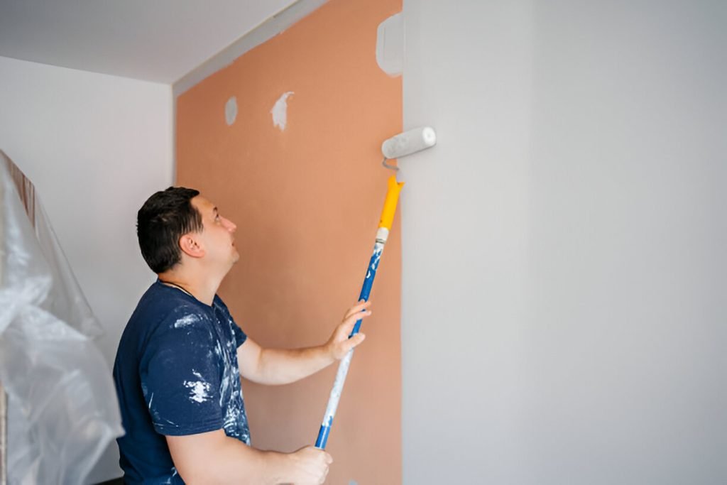 Mid-Adult Man Painting The Walls In His Apartment