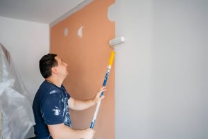 Mid-Adult Man Painting The Walls In His Apartment