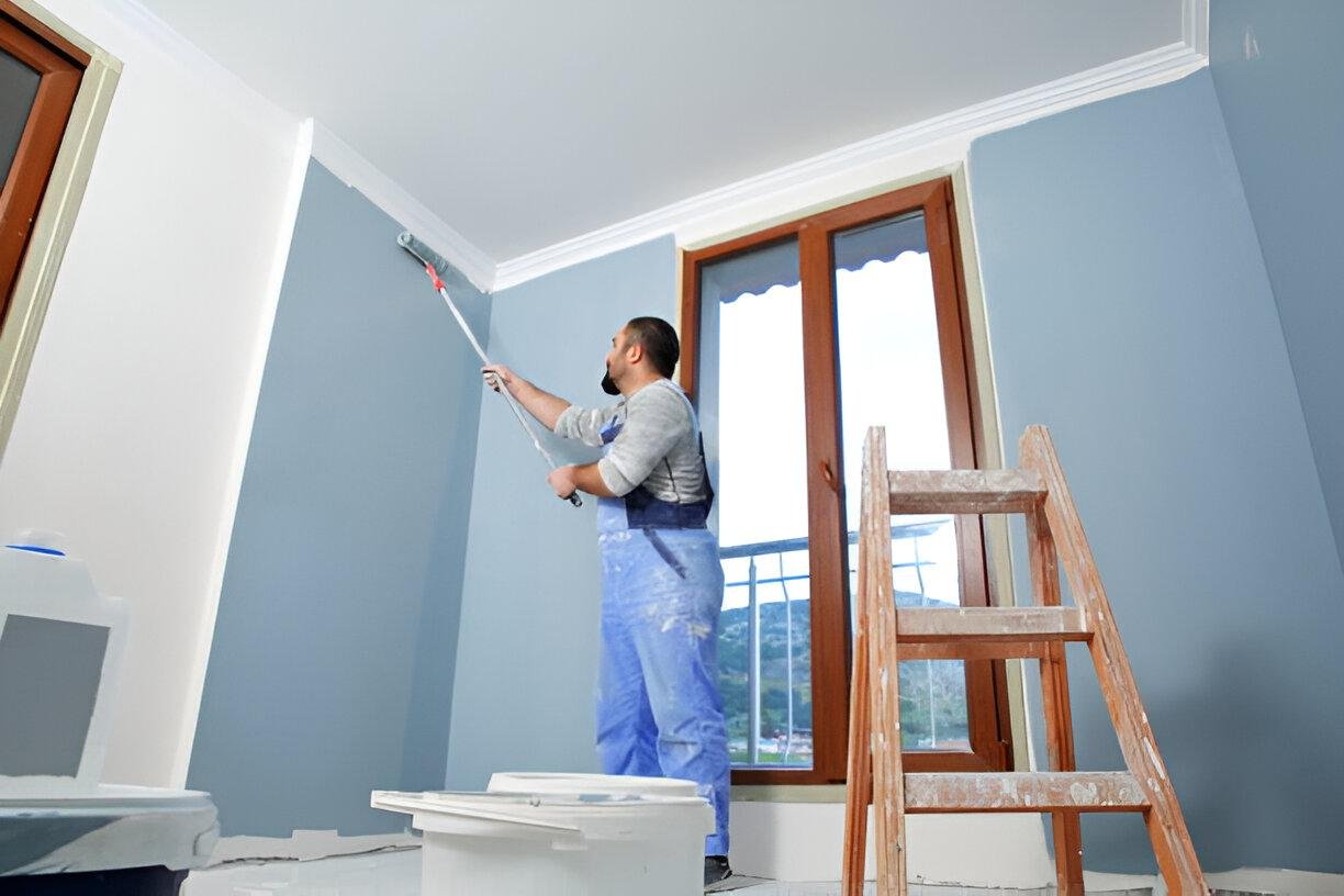 Man painting a room, contrasting DIY painting with professional services.