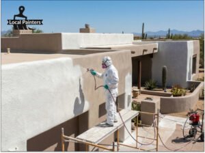 A professional applicator using a heavy-duty sprayer to apply a thick layer of coating to a desert home